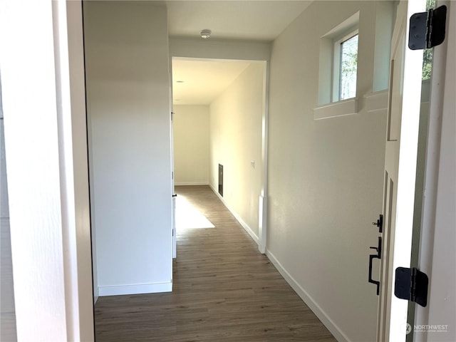 corridor featuring dark hardwood / wood-style flooring