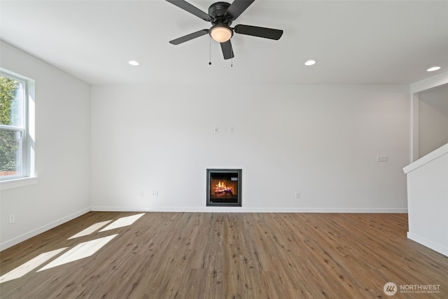 11114 NE 91st Ave, Vancouver, WA 98662 - unfurnished living room with ceiling fan, baseboards, a glass covered fireplace, recessed lighting, and wood finished floors