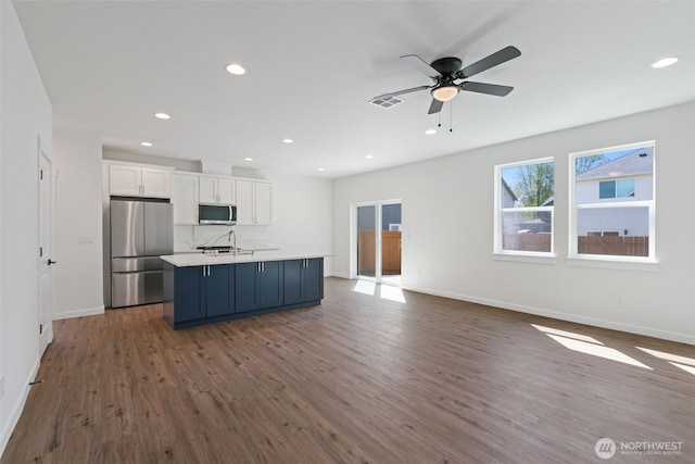 11114 NE 91st Ave, Vancouver, WA 98662 - kitchen featuring a kitchen island with sink, stainless steel appliances, dark wood-type flooring, visible vents, and white cabinets