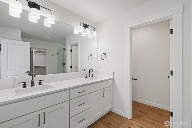 11114 NE 91st Ave, Vancouver, WA 98662 - bathroom featuring wood finished floors, baseboards, a stall shower, and a sink