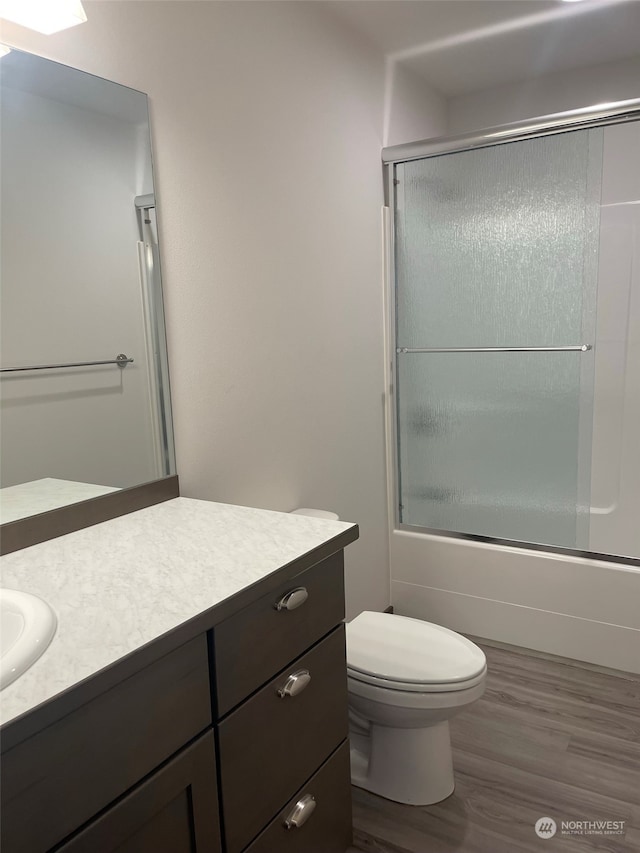 bathroom featuring hardwood / wood-style flooring, toilet, and vanity