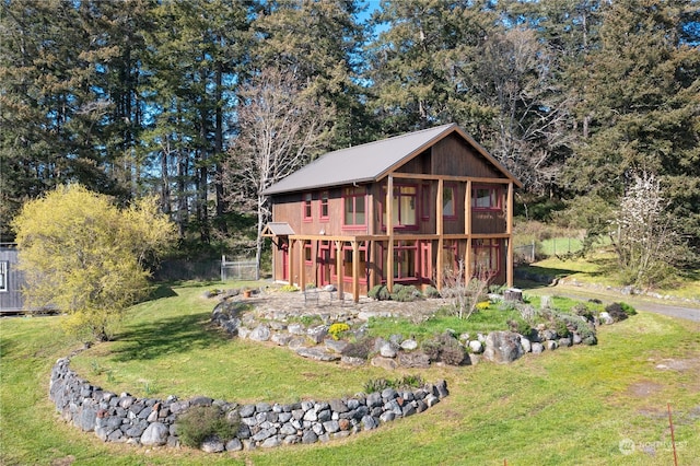 back of property with a yard and an outdoor structure