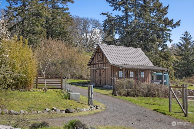 view of property's community with a yard and an outdoor structure