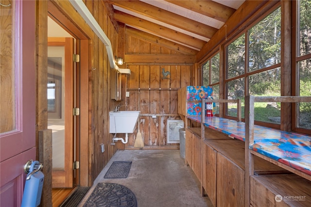 unfurnished sunroom with sink and lofted ceiling with beams