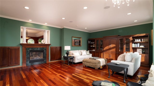 interior space featuring crown molding, a chandelier, dark hardwood / wood-style floors, and a premium fireplace