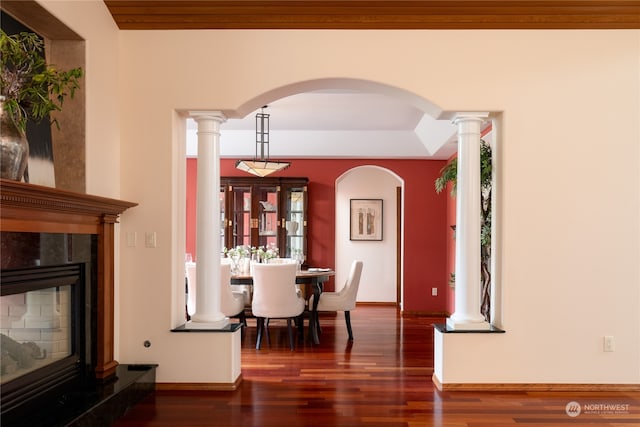 dining area with a healthy amount of sunlight, wooden ceiling, dark hardwood / wood-style floors, and ornate columns