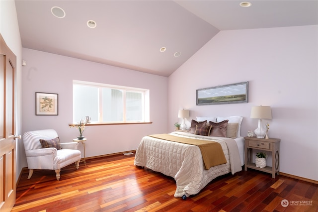 bedroom with high vaulted ceiling and wood-type flooring