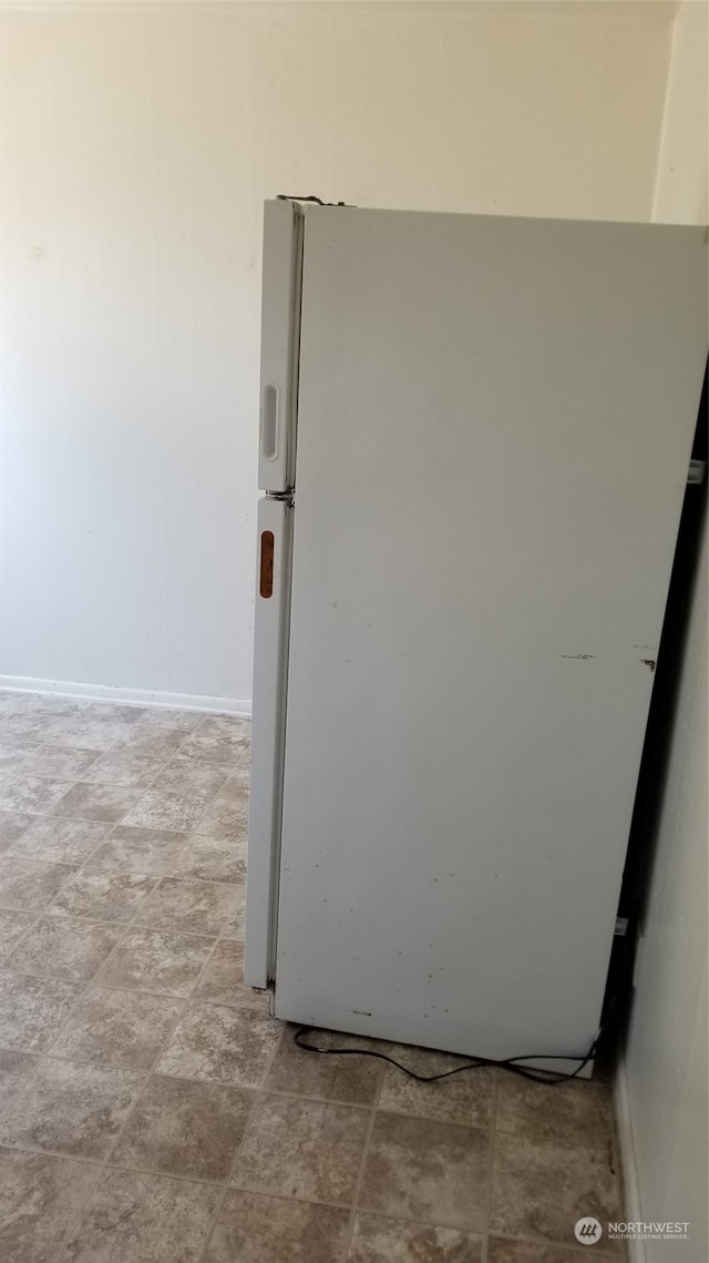 interior details with white fridge and light tile floors