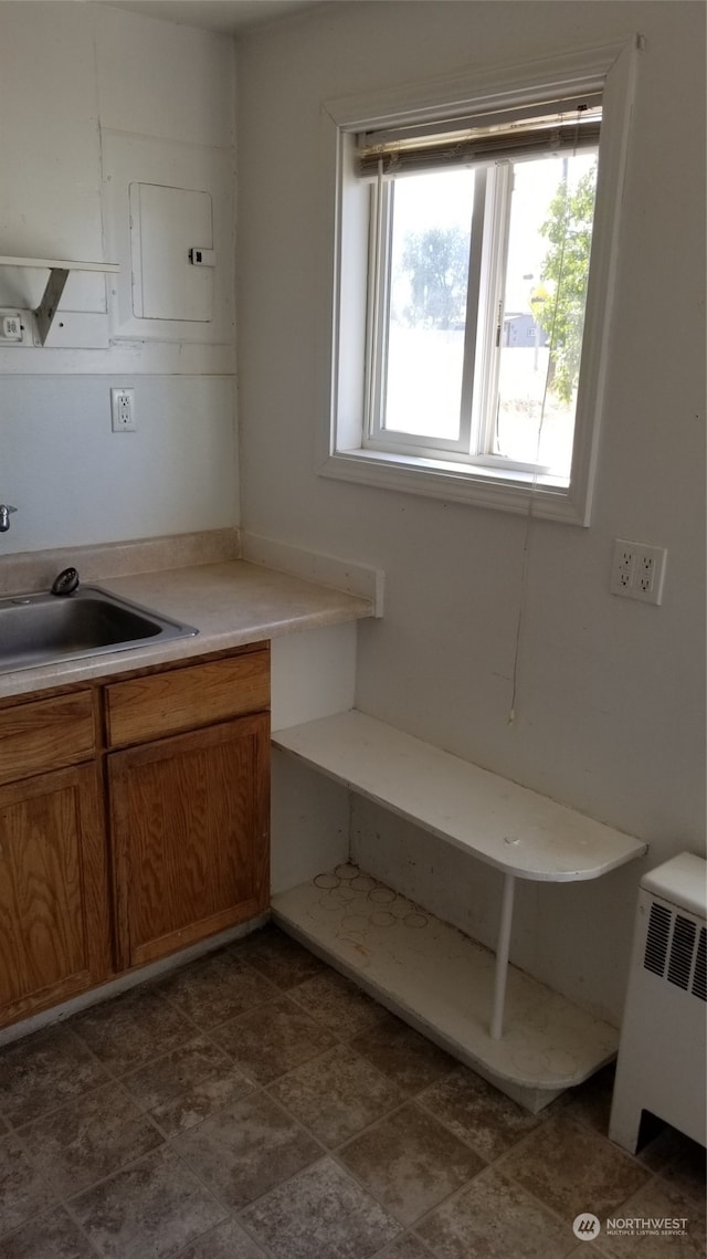 bathroom with tile floors, radiator, and sink