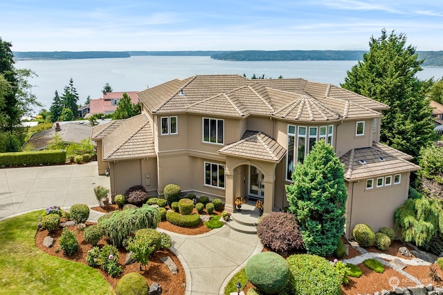 view of front of house with a water view