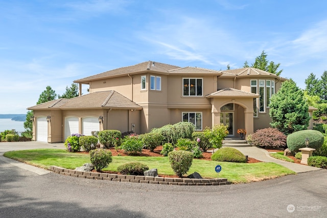 view of front of house with a front lawn and a garage