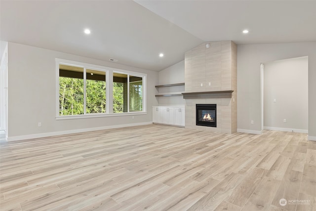 unfurnished living room with recessed lighting, a fireplace, baseboards, vaulted ceiling, and light wood-type flooring