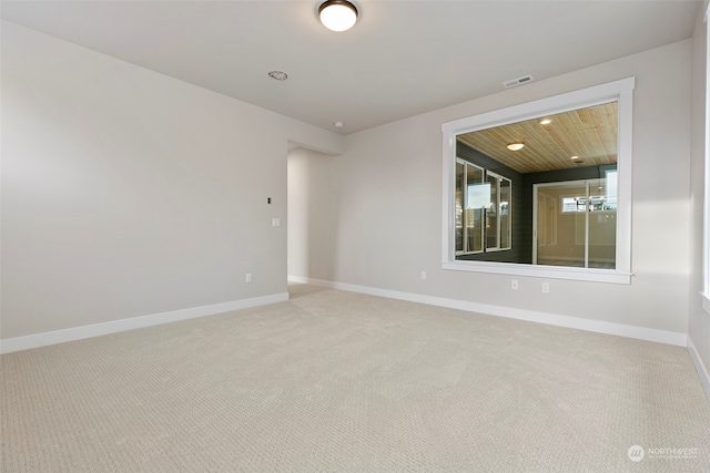 empty room with recessed lighting, visible vents, carpet flooring, wooden ceiling, and baseboards