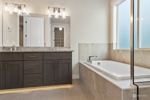 bathroom featuring double vanity, a bath, and tile patterned floors