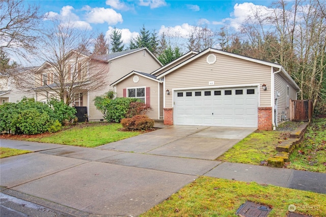 view of front of home with a front lawn and a garage