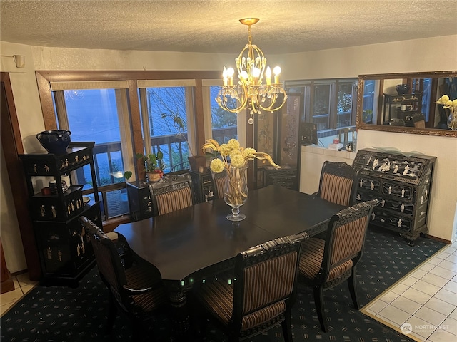 tiled dining area featuring a healthy amount of sunlight, a chandelier, and a textured ceiling