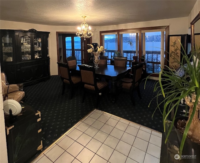 dining area with tile floors, a textured ceiling, and a notable chandelier