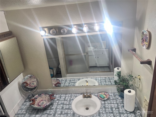 bathroom featuring sink and a textured ceiling