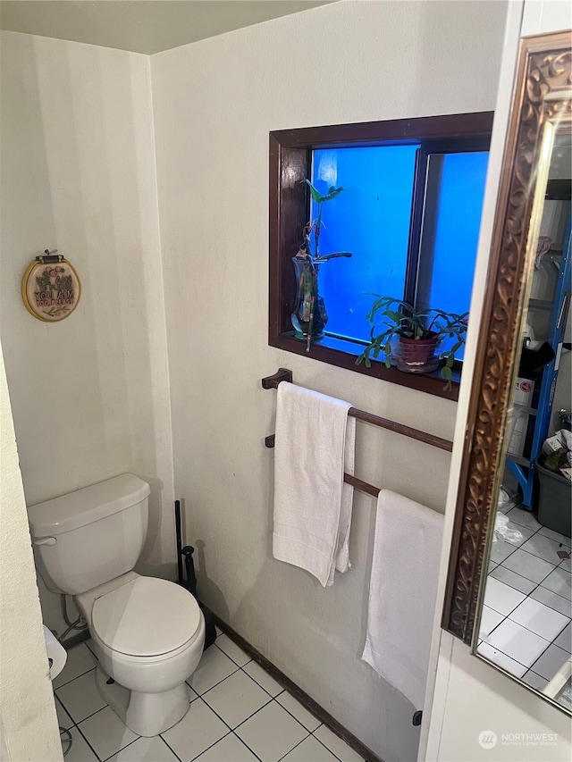 bathroom featuring toilet and tile floors