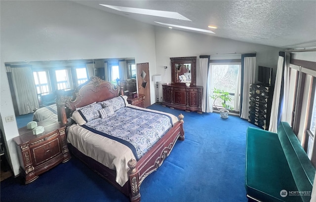 bedroom featuring a skylight, high vaulted ceiling, dark colored carpet, and a textured ceiling