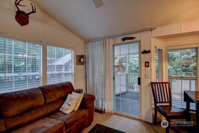 carpeted living room featuring vaulted ceiling