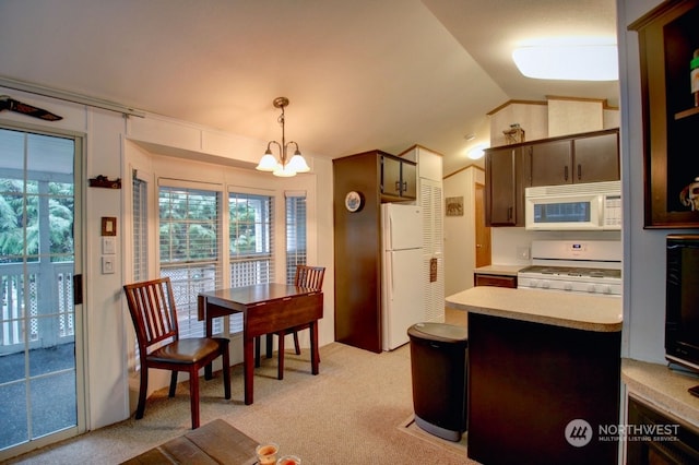 kitchen featuring an inviting chandelier, decorative light fixtures, white appliances, lofted ceiling, and dark brown cabinets