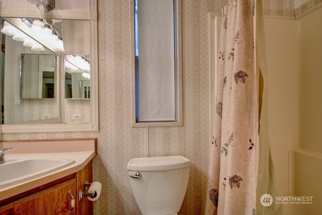 bathroom featuring vanity, toilet, and a shower with curtain