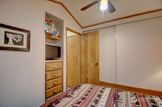 bedroom with crown molding, vaulted ceiling, ceiling fan, and a closet