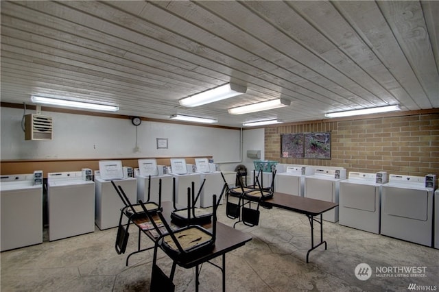 basement with brick wall and independent washer and dryer