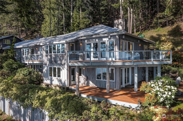 rear view of property featuring a wooden deck