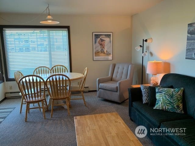 dining room featuring dark carpet