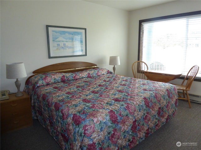 bedroom with a baseboard heating unit and carpet