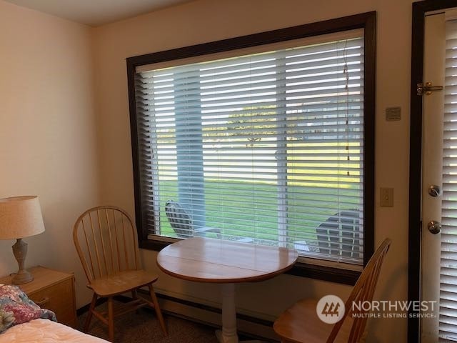 dining area with a healthy amount of sunlight and a baseboard heating unit