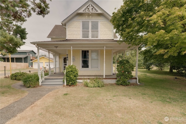 view of front of home featuring a front yard and a porch