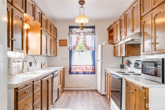 kitchen with backsplash, light hardwood / wood-style flooring, decorative light fixtures, stainless steel appliances, and sink