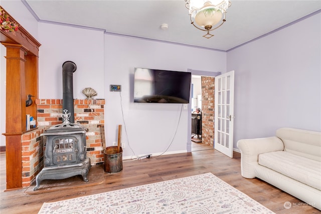 living room featuring a wood stove and wood-type flooring