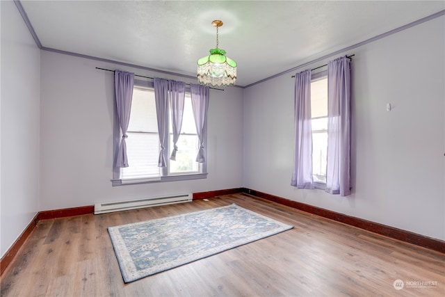 unfurnished room featuring ornamental molding, hardwood / wood-style flooring, baseboard heating, and an inviting chandelier