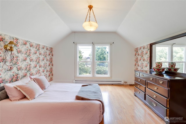 bedroom featuring lofted ceiling, baseboard heating, and light hardwood / wood-style floors