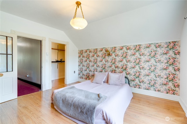 bedroom featuring lofted ceiling and hardwood / wood-style flooring