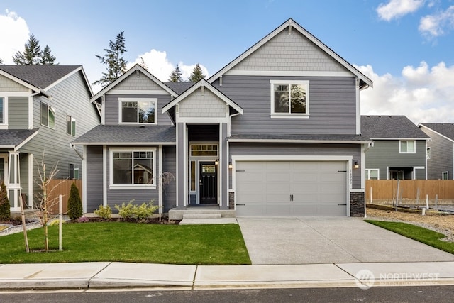 craftsman inspired home featuring a front lawn and a garage