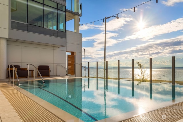 view of swimming pool with a water view