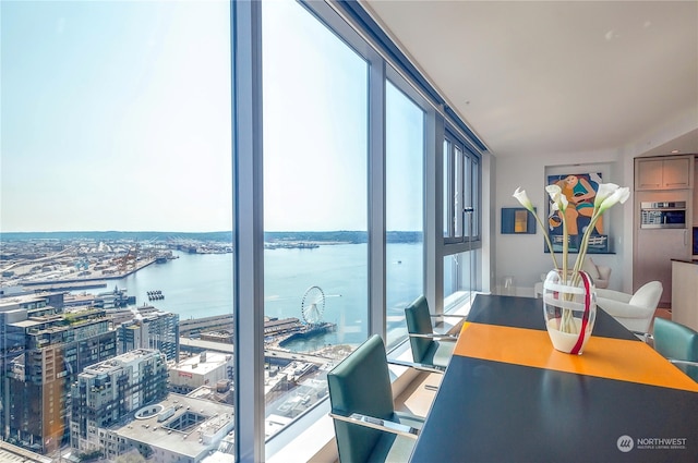 home office with floor to ceiling windows and a water view