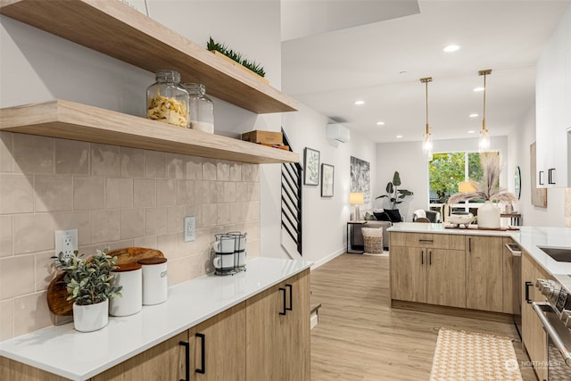 kitchen with light wood-type flooring, tasteful backsplash, light brown cabinets, an AC wall unit, and hanging light fixtures