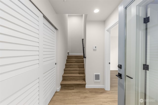 staircase with wood-type flooring