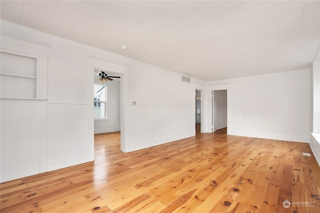 empty room with ceiling fan and light wood-type flooring