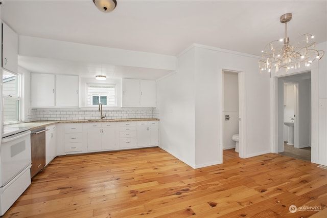 kitchen with pendant lighting, light hardwood / wood-style flooring, white cabinetry, sink, and an inviting chandelier