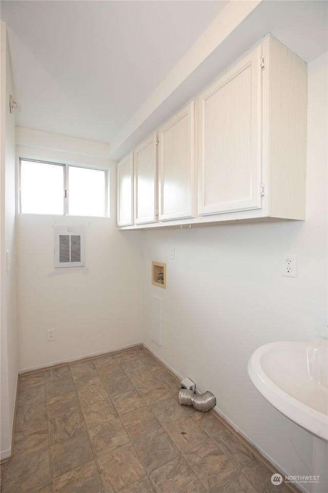 laundry room featuring sink, cabinets, dark tile floors, and hookup for a washing machine