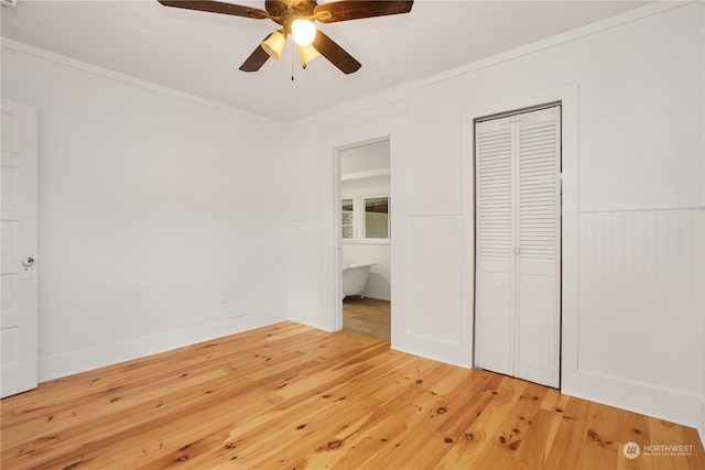 unfurnished bedroom with ceiling fan, a closet, ornamental molding, and light hardwood / wood-style floors