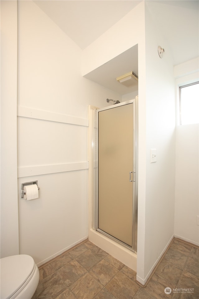 bathroom with walk in shower, tile flooring, and toilet