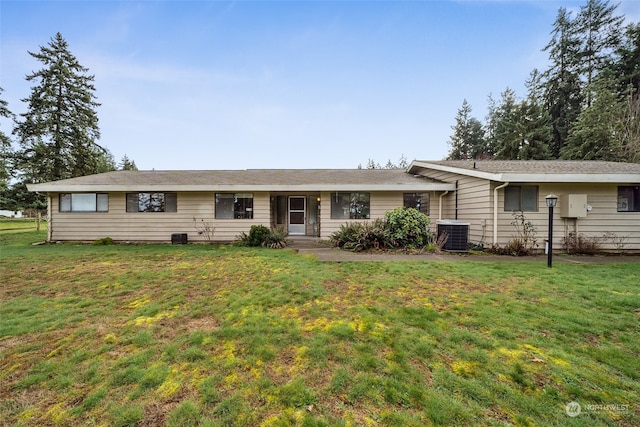 ranch-style home featuring a front yard and central air condition unit